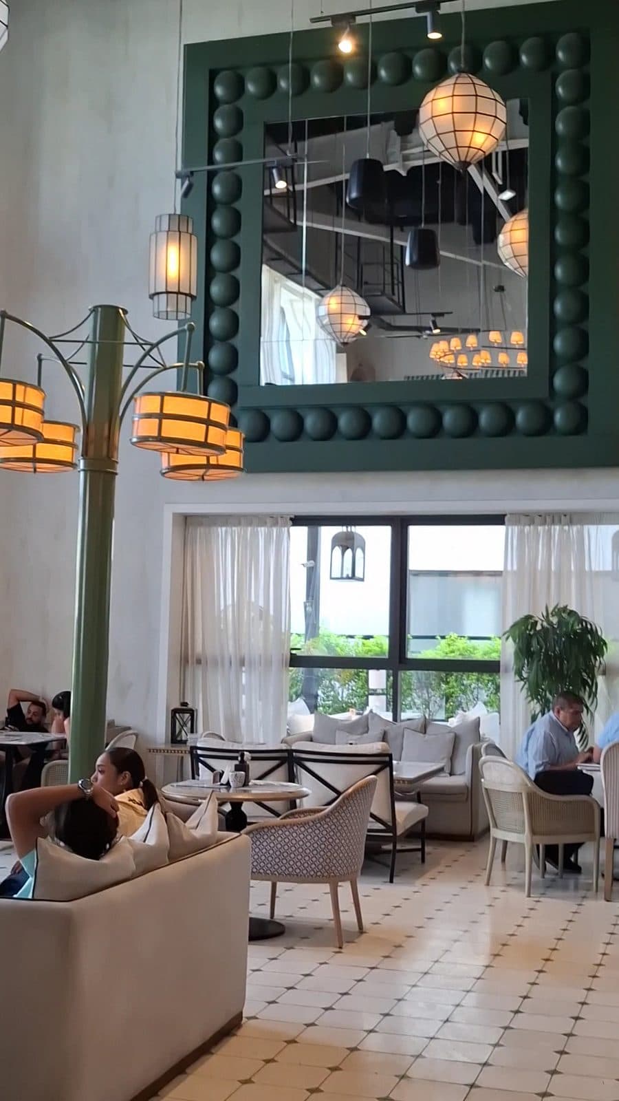 The lounge seating at Willow's District 5, with chandeliers and tall windows.